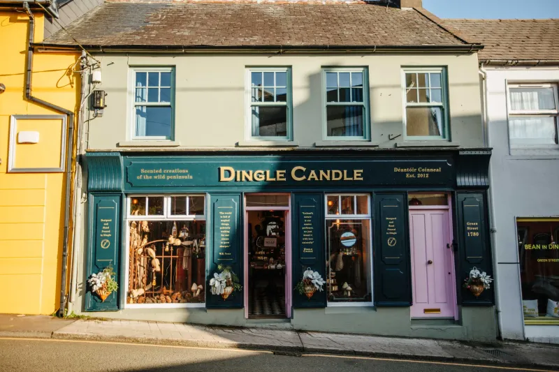 A storefront with a dark teal facade and gold lettering reading 